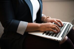 Woman typing 'what does private security cost in the UK?'